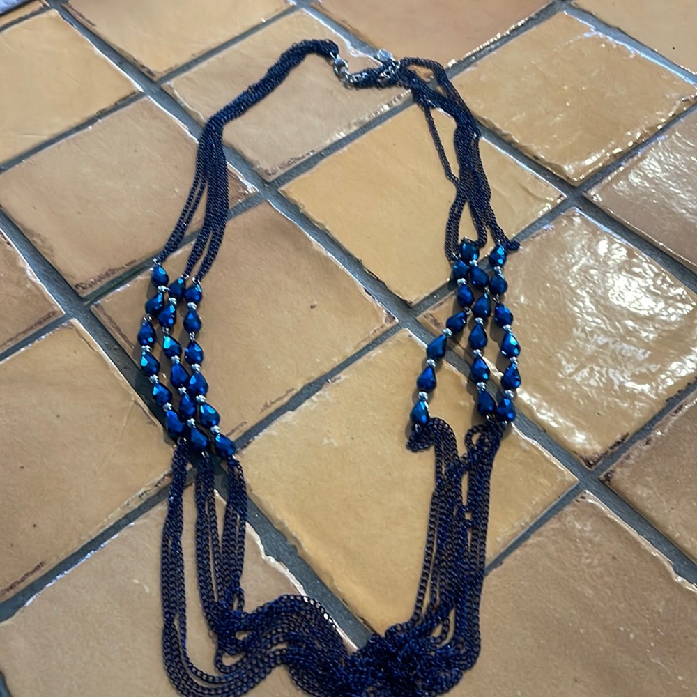 6 to 3 strand blue bead necklace. 34 inches